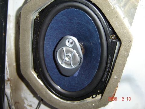 1993 Ford Bronco - A close-up view of a car's interior speaker, showing its blue cone and silver tweeter.