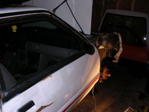 1988 Ford Mustang - Interior view of a 1988 Ford Mustang, showing the dashboard and door panel. Another vehicle is partially visible.
