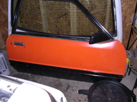1988 Ford Mustang - Car door with orange and black paint, likely a replacement part.