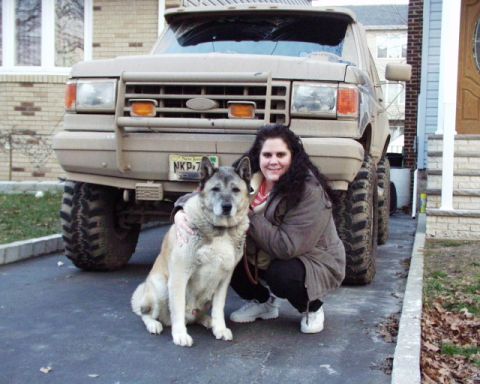 1989 Ford Bronco - A woman and her dog pose in front of a heavily modified Ford Bronco, possibly from the late 1980s.