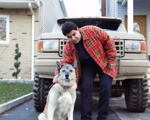 1989 Ford Bronco - A man and his dog pose in front of a 1989 Ford Bronco.