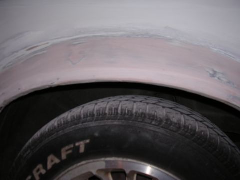 1988 Ford Mustang - A close-up view of a vehicle's wheel well and tire, showing bodywork in progress.
