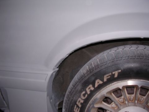 1988 Ford Mustang - Detail shot of a tire and wheel well, with "SUPERMOTORS" branding on the tire.