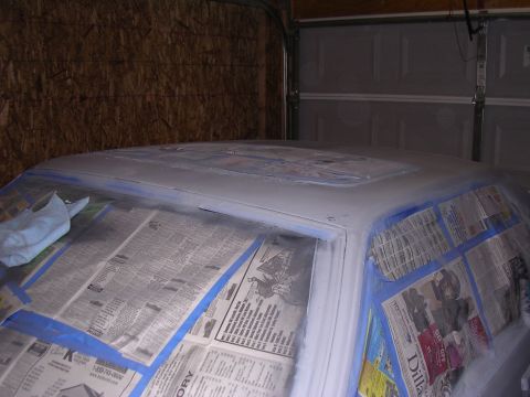 1988 Ford Mustang - A car's roof is taped off with newspaper and blue tape, ready for a fresh coat of primer.
