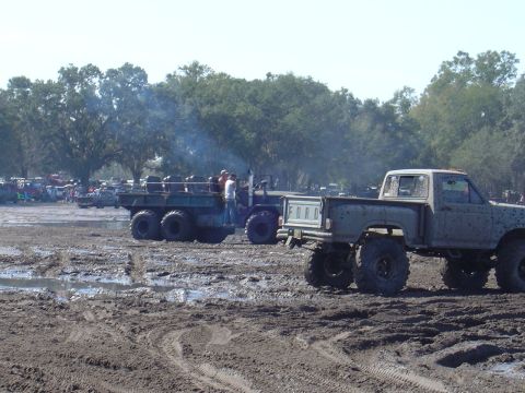 1987 Suzuki Samurai - Several modified trucks are stuck in a muddy off-road event.