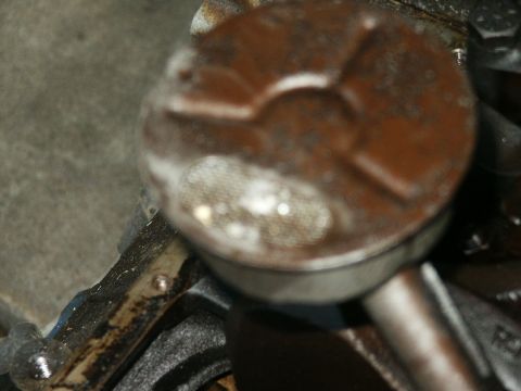 1991 Ford Bronco - This is a close-up view of an engine piston, showing some signs of use and lubrication.