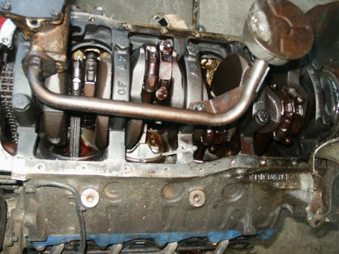 1991 Ford Bronco - Close-up view of an engine's internal components, including the crankshaft and connecting rods.