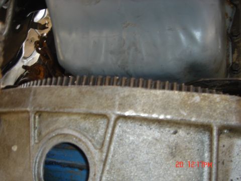 1991 Ford Bronco - Close-up view of engine components, including the flywheel and oil pan.