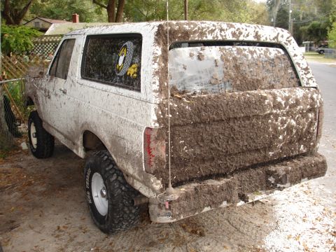 1989 Ford Bronco - This 1989 Ford Bronco is heavily covered in mud, obscuring much of its original appearance.