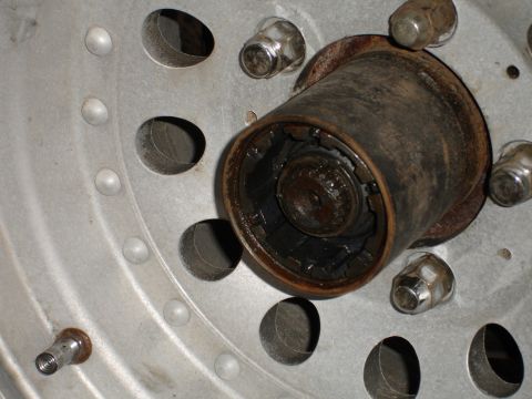 1989 Ford Bronco - Wheel hub assembly showing lug nuts and a valve stem, with Supermotors.net logo in the corner.