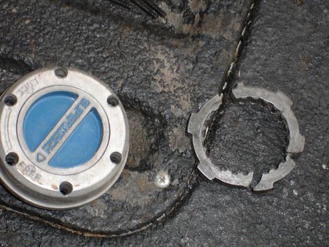 1989 Ford Bronco - A close-up shows a Superwinch hubcap and a damaged locking ring, suggesting a focus on vehicle parts rather than a specific model year.