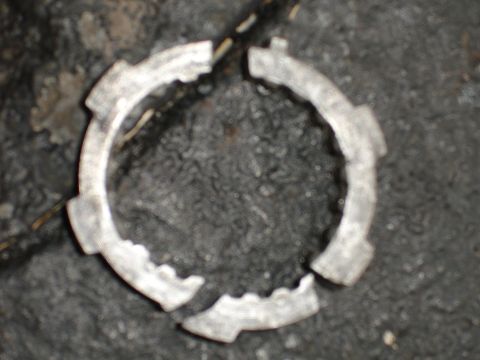 1989 Ford Bronco - This is a broken metal ring with notches, likely a component from a vehicle.
