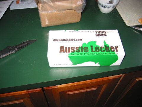 1991 Ford Explorer - A box for an Aussie Locker is shown on a green countertop next to a knife and a cardboard box.