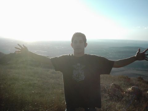 1978 Ford Bronco - A person stands on a hill with arms spread wide, overlooking a city below.