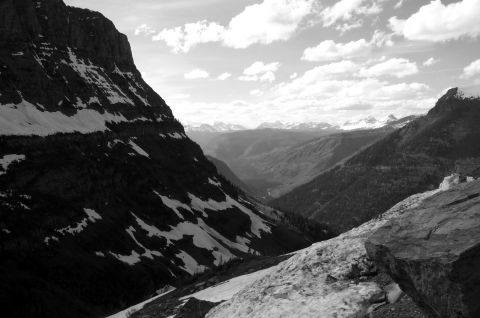 1996 Ford Bronco - A scenic mountain vista with snow-capped peaks and a road visible in the distance, captured in a black and white photograph.