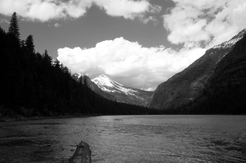 1996 Ford Bronco - A scenic view of a lake with mountains and trees under a cloudy sky.