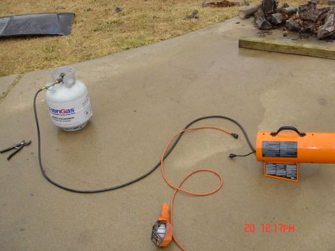 1991 Ford Bronco - A propane tank is connected to an orange torpedo heater, with a work light nearby, suggesting preparation for an engine rebuild or similar…