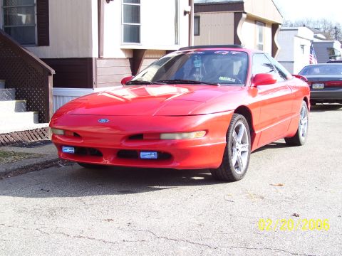 1994 Ford Probe - Front view of a red 1994 Ford Probe, showing its distinctive body style and aftermarket fog lights.