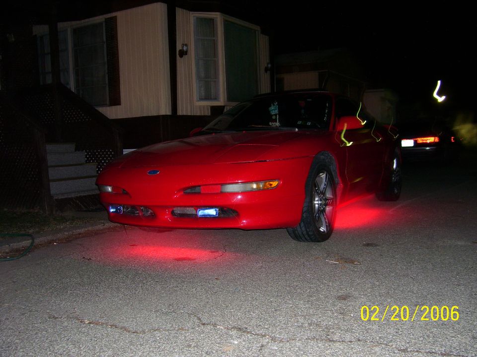 1994 Ford Probe front view with red underglow lights parked at night