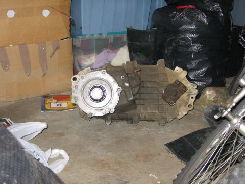 1987 Ford Bronco - A transfer case unit is shown on the floor, surrounded by storage items.