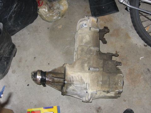 1987 Ford Bronco - This is a Ford transfer case, likely from a truck or SUV, shown on a garage floor.