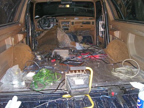 1991 Ford Bronco - The interior of a 1991 Ford Bronco shows extensive exposed wiring and electrical equipment, suggesting a rewiring project.