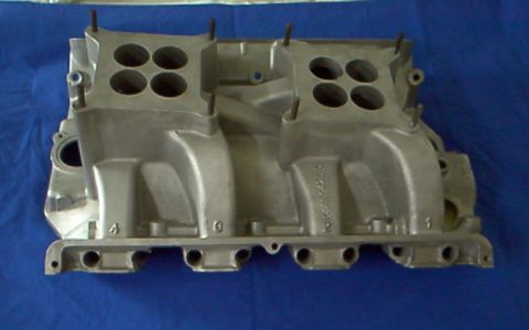 1964 Ford Fairlane - This aluminum intake manifold features a dual quad setup with four carburetor ports visible.