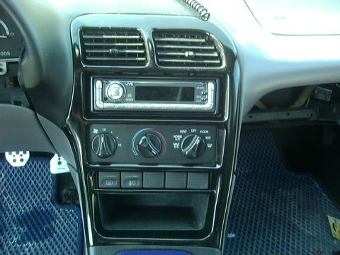 1995 Ford Probe - Interior view of a car's dashboard with aftermarket stereo and climate controls.
