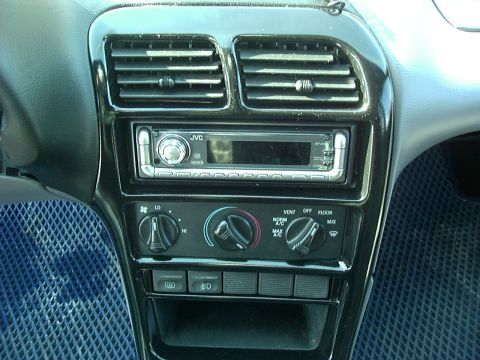 1995 Ford Probe - Close-up of a car's center console showing the stereo and HVAC controls.
