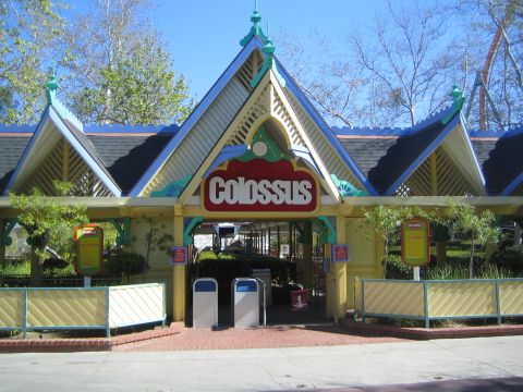 1990 Ford Bronco - yellow and blue gabled amusement park ride entrance displays a red 'Colossus' sign above the gate.