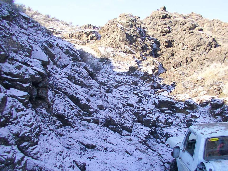 White pickup truck on snowy mountain road