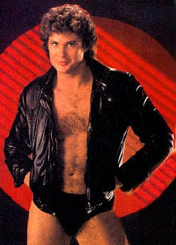 1991 Ford Bronco - A man poses in a leather jacket and briefs against a red background.