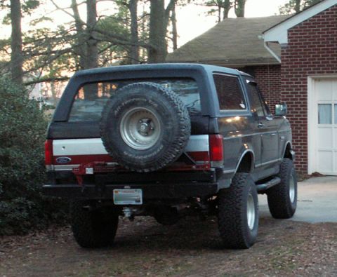 1988 Ford Bronco - Rear view of a 1988 Ford Bronco, showing its spare tire and custom bumper details.