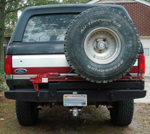 1988 Ford Bronco - The rear of a Ford Bronco shows a spare tire and a black bumper, with a license plate visible.