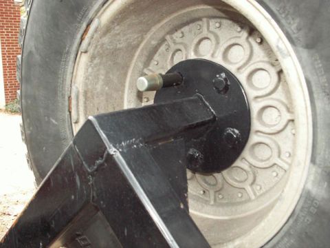 1988 Ford Bronco - Spare tire mount bracket attached to a wheel hub, likely for an off-road vehicle.