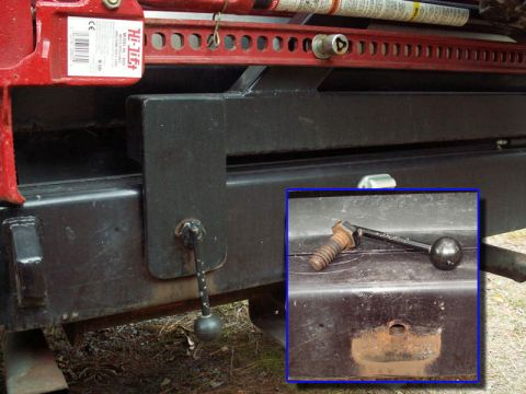 1988 Ford Bronco - A Hi-Lift jack is mounted to the rear bumper of a vehicle, with a close-up of the mounting hardware.