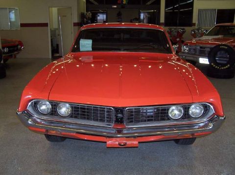 1970 Ford Ranchero - Front view of a red 1970 Ford Ranchero, a distinctive grille and quad headlights.