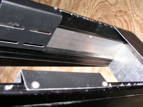 1999 Ford Crown Victoria - Close-up of a vehicle's interior console, showing its construction and mounting hardware.