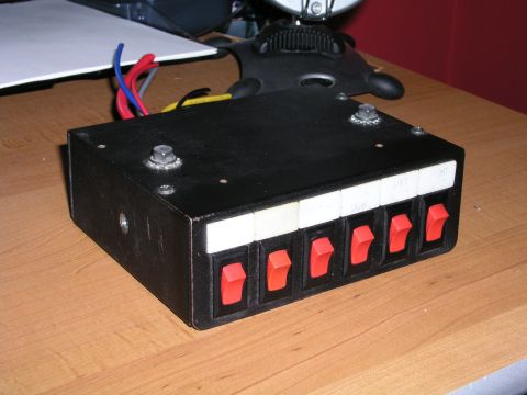 1999 Ford Crown Victoria - Aftermarket switch panel with red toggle switches and wiring. Likely for auxiliary lights or accessories.