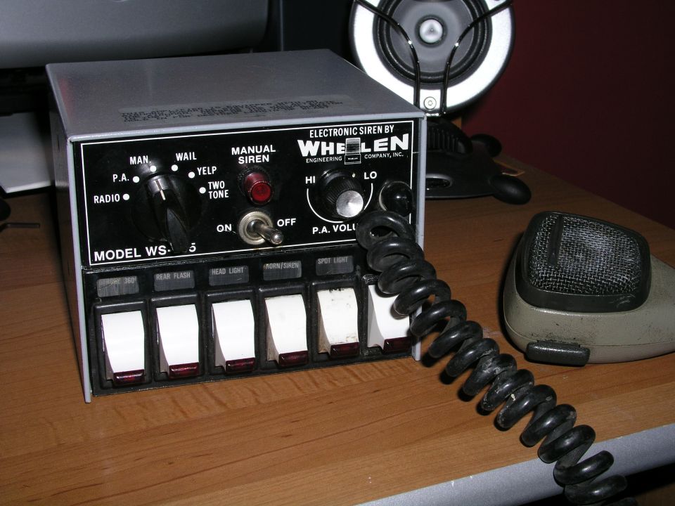 Whelen siren control unit with multiple switches and a microphone