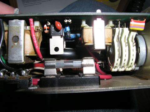 1999 Ford Crown Victoria - Close-up of an electronic circuit board showing internal components like a fuse and switches.