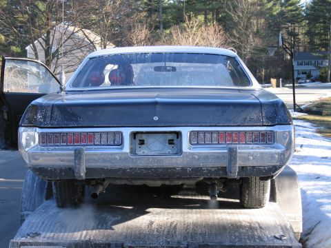 1991 Ford LTD Crown Victoria - Rear view of a dusty dark two-door coupe on a trailer, showing wide horizontal taillights and chrome bumper.
