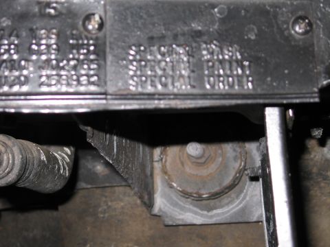 1991 Ford LTD Crown Victoria - close view of a metal fender tag with stamped codes and the legible words SPECIAL PAINT and SPECIAL ORDER beside engine-bay hardware.