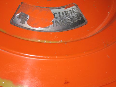 1991 Ford LTD Crown Victoria - peeling chrome cubic-inch displacement decal on the lid of a glossy orange engine air-cleaner housing.
