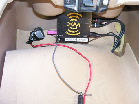 1991 Ford Bronco - Close-up of an XM radio module and its wiring harness, installed in a vehicle's interior.
