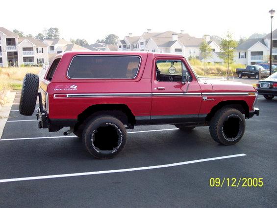 Red 1979 Ford Bronco with spare tire on rear, 3q-front view