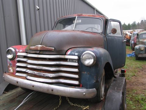 1949 Chevrolet C/K Pickup - This 1949 Chevrolet C/K Pickup truck shows significant rust and wear, with its driver's side door ajar.