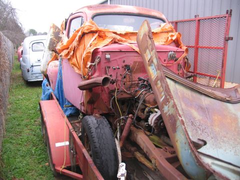 1952 Ford Pickup - This 1952 Ford Pickup is in rough condition and being transported on a trailer.