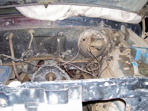 1979 Ford Bronco - View of the engine bay, focusing on the brake booster and associated wiring.