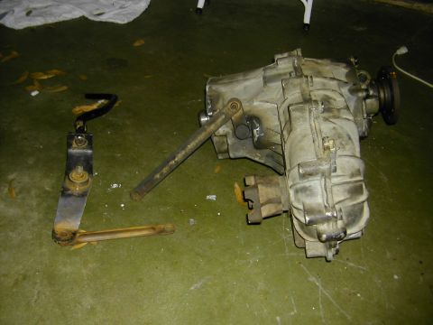 1993 Ford Bronco - This photo shows a disassembled transfer case and its associated linkage components, likely for a vehicle repair or modification.